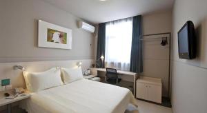 Una televisión o centro de entretenimiento en Jinjiang Inn Changchun Pepole Square