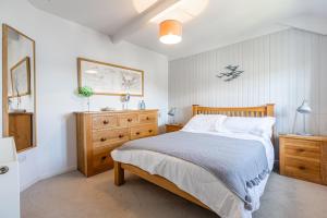 En eller flere senge i et værelse på 3 Glendale Cottages