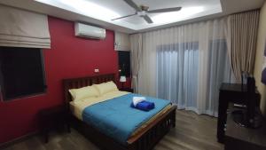 a bedroom with a bed with a blue blanket at Villa Whitney in Lamai +18 photos