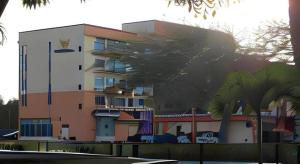 a building with a palm tree in front of it at Kingwood Hotel Mukah in Mukah