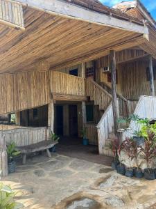 a wooden building with a bench in front of it at Waddy Inn and Leisure Farm in Taytay