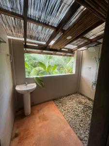 a bathroom with a sink and a window at Waddy Inn and Leisure Farm in Taytay