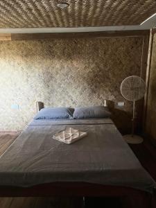 a bed with a tray on top of it at Waddy Inn and Leisure Farm in Taytay