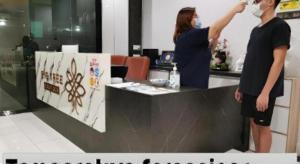 two people standing at a counter in a kitchen at Big Tree Boutique in Ipoh