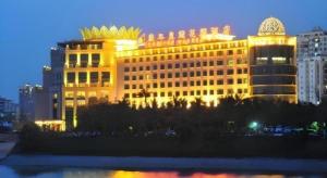 a large building with a gold crown on top of it at Haikou Conifer Garden Hotel in Haikou