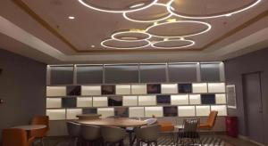 a dining room with tables and chairs and a chandelier at Magnotel Harbin Medical University First Affiliated Hospital in Harbin