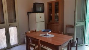 - une salle à manger avec une table et une télévision dans l'établissement San Pietro Apartments, à San Pietro in Bevagna