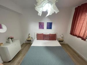 a bedroom with a large bed and a chandelier at Sofia TS apartment in Craiova