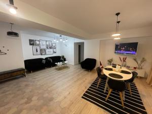 a living room with a couch and a table at Sofia TS apartment in Craiova