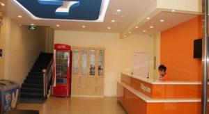 a person in a store with a red coke machine at 7 Days Inn Qinhuangdao Changjiang Road Chinese Medicine Hospital Branch in Qinhuangdao