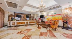 a large room with a couch and chairs in it at GreenTree Alliance Anhui Hefei South Passenger Station South High Speed Railway Station Hotel in Hefei