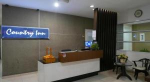 a lobby of a company with a sign on the wall at Country Inn in Kampong Saleng