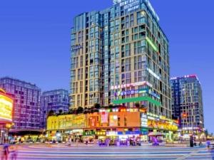 a large tall building in a city at night at GreenTree Inn Sichuan Chengdu Airport Road Express Hotel in Chengdu