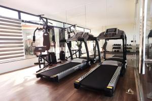 a gym with several treadmills and a mirror at AEROSTOP HOTEL & RESTAURANT in Kutkot