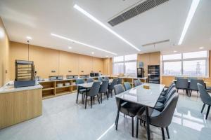 a conference room with tables and chairs in a building at GreenTree Inn Suzhou North Zhongshan Road Weiye Yingchun Plaza Business Hotel in Suzhou