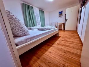 a small room with a bed with a window at 92 City Rooms in Koblenz