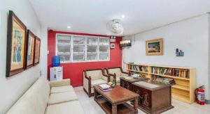a living room with a couch and a table at RedDoorz near Cebu Metropolitan Cathedral in Adlawon