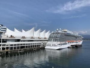 two cruise ships are docked next to a dock at 2 bedroom heart of Central Surrey in Surrey