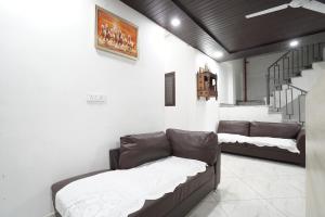 a living room with two couches and a couch at CITY CHARM Home Stay in Dehradun