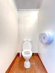 ワナカにあるMt Aspiring Holiday Parkのバスルーム(トイレ付)、壁に紙製ディスペンサーが備わります。