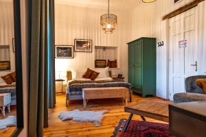 a bedroom with a bed and a green cabinet at Ugron Castle Fiatfalva in Cristuru Secuiesc