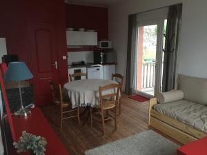 a living room with a table and a couch at Le Fil du Temps in Le Bény-Bocage