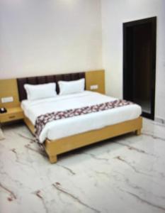 a bedroom with a large bed in a room at Shree Radha inn in Ayodhya +8 photos