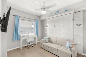 a living room with a couch and a crib at Ocean Oaks PHB-8 in Cape Canaveral