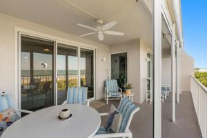 a patio with a table and chairs on a balcony at Ocean Oaks PHB-8 in Cape Canaveral