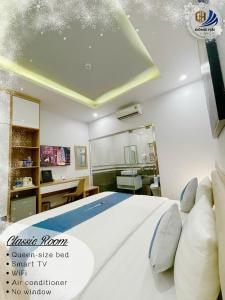 a bedroom with a bed with a white bedvisor at Dong Hai Hotel _ Rach Gia in Rach Gia