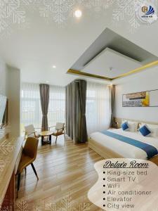 a hotel room with a bed and a desk at Dong Hai Hotel _ Rach Gia in Rach Gia