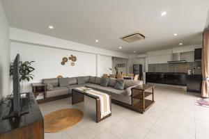 a living room with a couch and a table at Staylar Seaview Pool Villa Gina Chaweng Noi in Bophut 