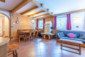 a living room with a blue couch and a table at Cesa Vivi in Canazei