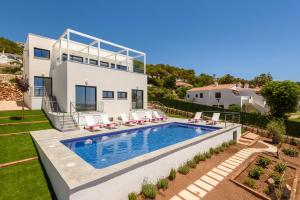 a villa with a swimming pool and a house at Villa Dolce Vita by Escape Home in Son Bou