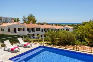 a villa with a swimming pool and a house at Villa Dolce Vita in Son Bou