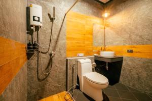a bathroom with a shower and a toilet and a sink at Lanta Chaolay in Ko Lanta +49 photos