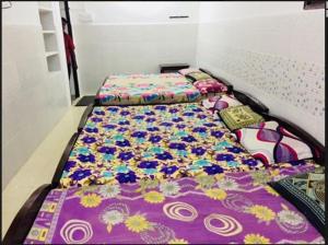 two beds sitting next to each other in a room at JS Homestay in Nāgercoil