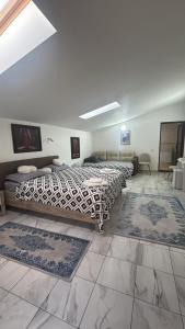 a room with three beds and rugs on the floor at Casa Rustica Cernica in Cernica