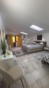 a living room with two beds and a chair at Casa Rustica Cernica in Cernica +58 photos