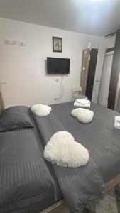 two white pillows on a bed in a bedroom at Casa Rustica Cernica in Cernica