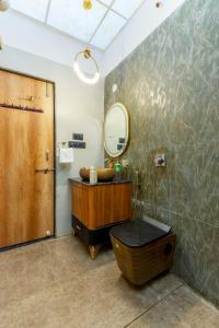 a bathroom with a sink and a mirror and a tub at SaffronStays Shreevats in Bedla +27 photos
