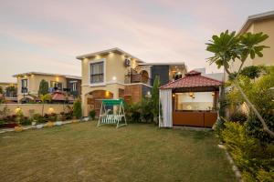 a house with a yard in front of it at SaffronStays Shreevats in Bedla