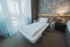 Ένα ή περισσότερα κρεβάτια σε δωμάτιο στο Rodinný Hotel Hubert High Tatras