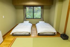 Una cama o camas en una habitación de 湯音の櫻