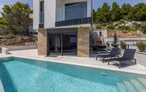 a villa with a swimming pool and a house at Luxurious Home In Dingac With Sauna in Gornji Dingač