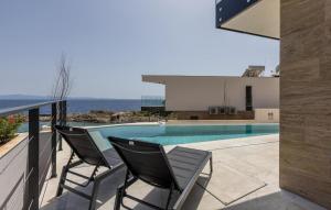 a balcony with two chairs and a swimming pool at Luxurious Home In Dingac With Sauna in Gornji Dingač +47 photos