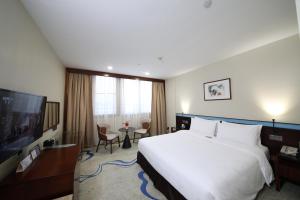 a hotel room with a large bed and a tv at Liuhua Hotel in Guangzhou