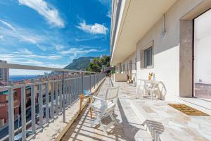 a balcony with chairs and a view of the ocean at New Panoramic studio overlooking Monaco in Beausoleil