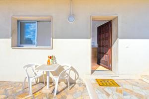 a room with a table and chairs and a door at New Panoramic studio overlooking Monaco in Beausoleil