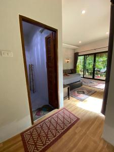a room with a mirror and a bedroom with a bed at Ingtara Lanta Valley in Ko Klang